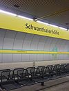 Munich U-Bahn station Schwanthalerhöhe platform with sign and wall.JPG